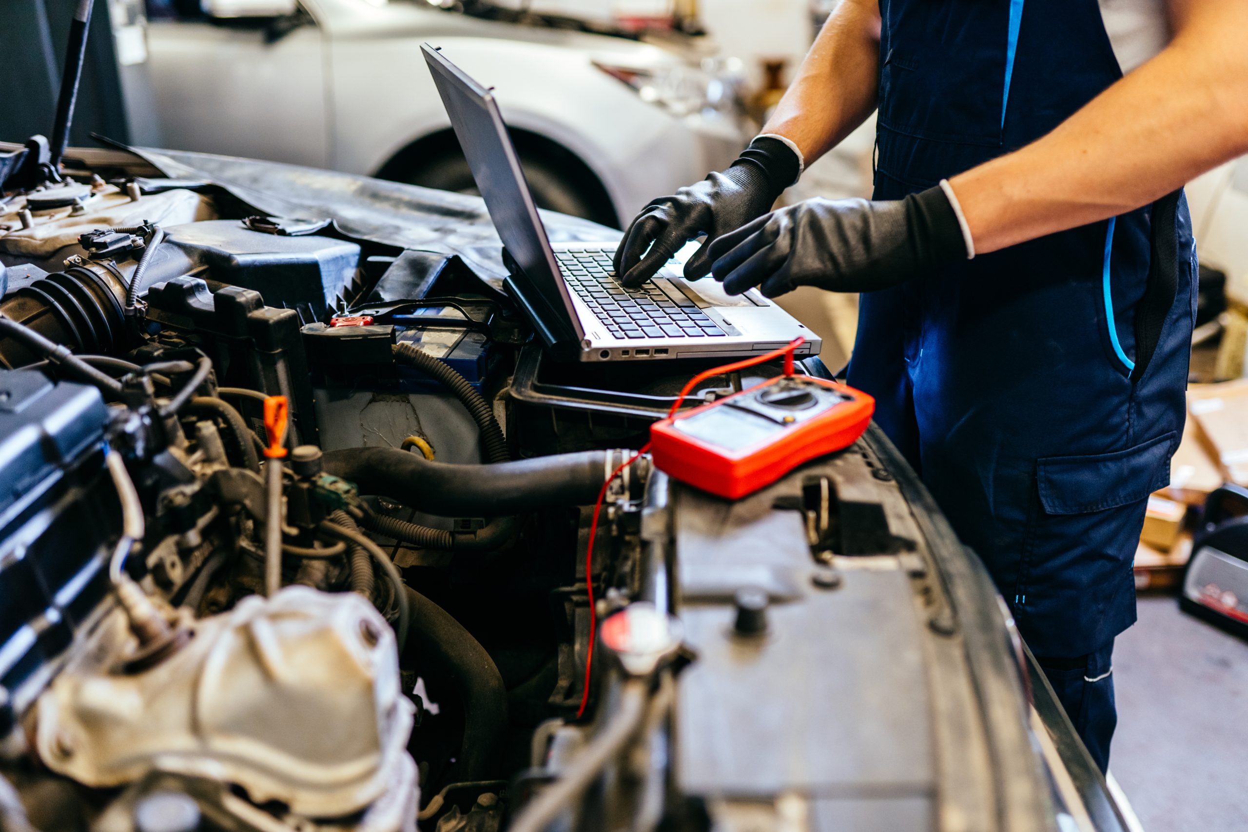 Technician using a laptop for vehicle diagnostics